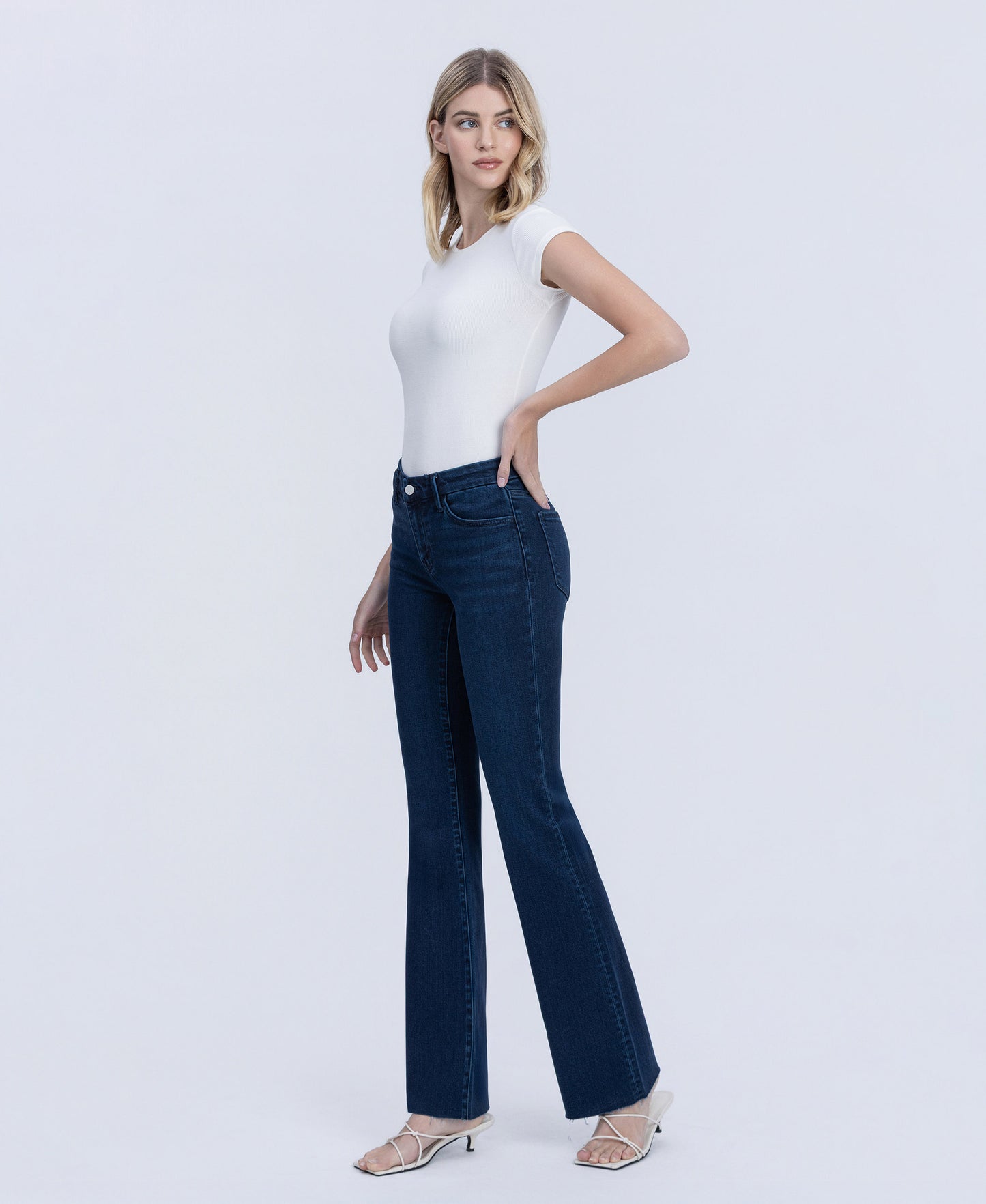 Left 45 degrees product image of Periwinkle - Mid Rise Raw Hem Tinted Bootcut Jeans