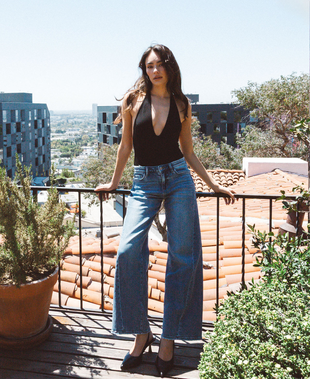 editorial image of Great - Mid Rise Distressed Waistband Twisted Wide Leg Jeans
