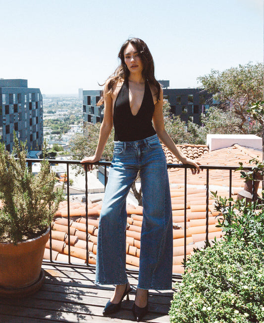 editorial image of Great - Mid Rise Distressed Waistband Twisted Wide Leg Jeans